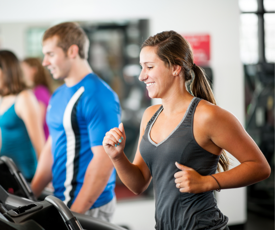 Smialing Woman jogs on a treadmill Smialing Woman jogs on a treadmill