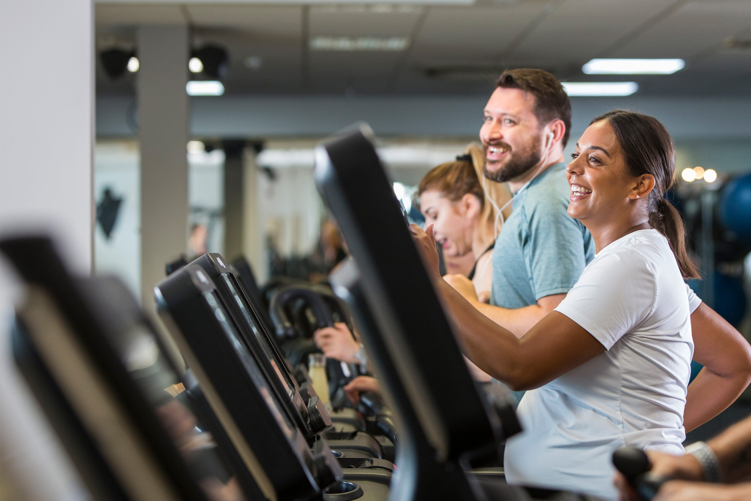 MTA-02-0184-resized-flipped-1 Man and woman using treadmills in the gym