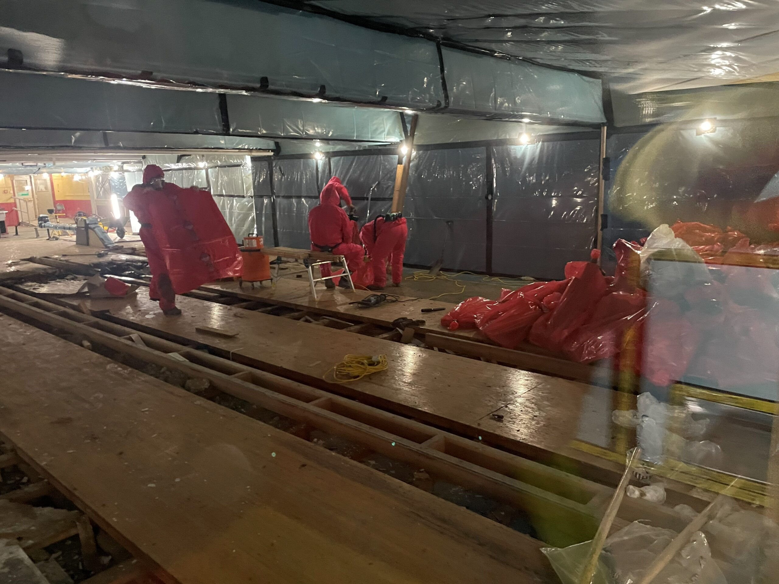 image005 people in safety suits undertaking asbestos removal of disused bowling alley